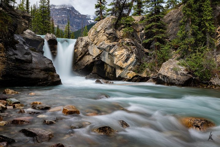 Twin Falls in the Cline River Valley, Alberta, Canadian Rockies – long exposure with silky water and rocks in the foreground, photographic art by Bernhard Houy